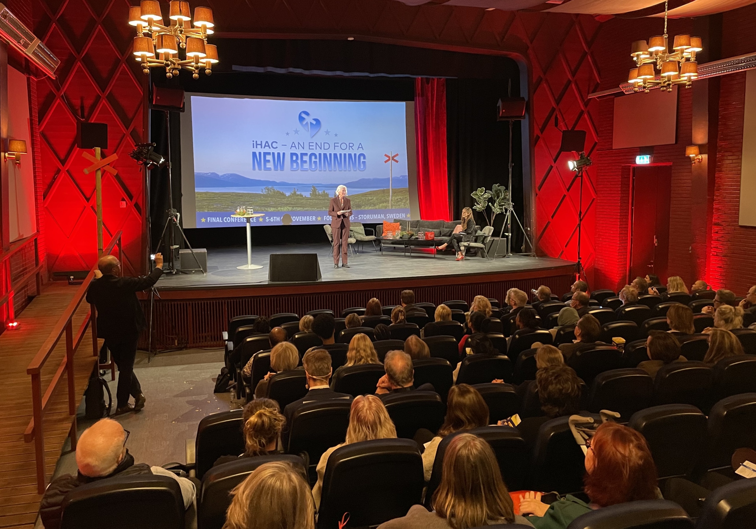 Minister Acko Ankarberg Johansson giving a speech in a cinema hall