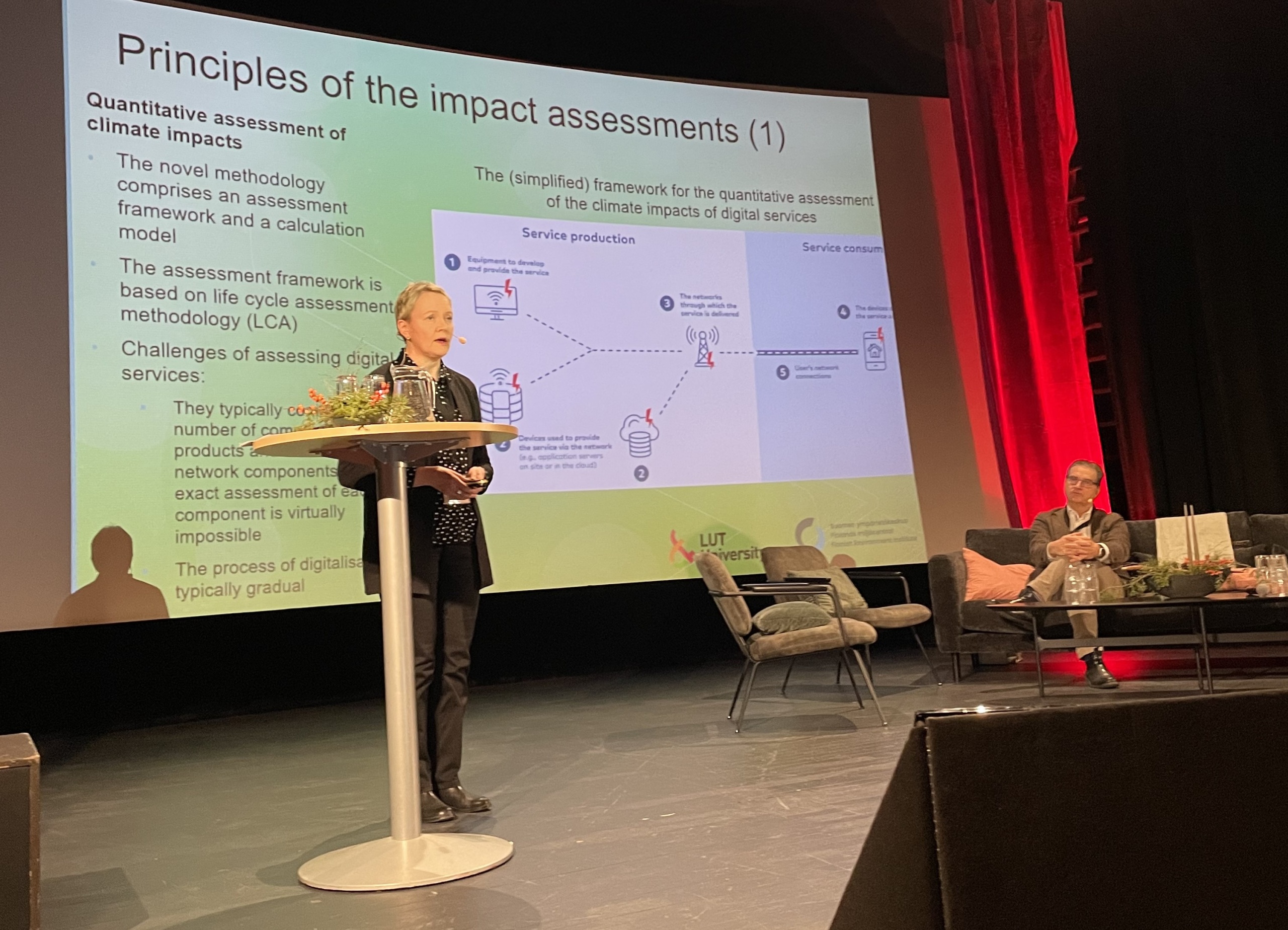 Helinä Melkas giving a presentation on stage