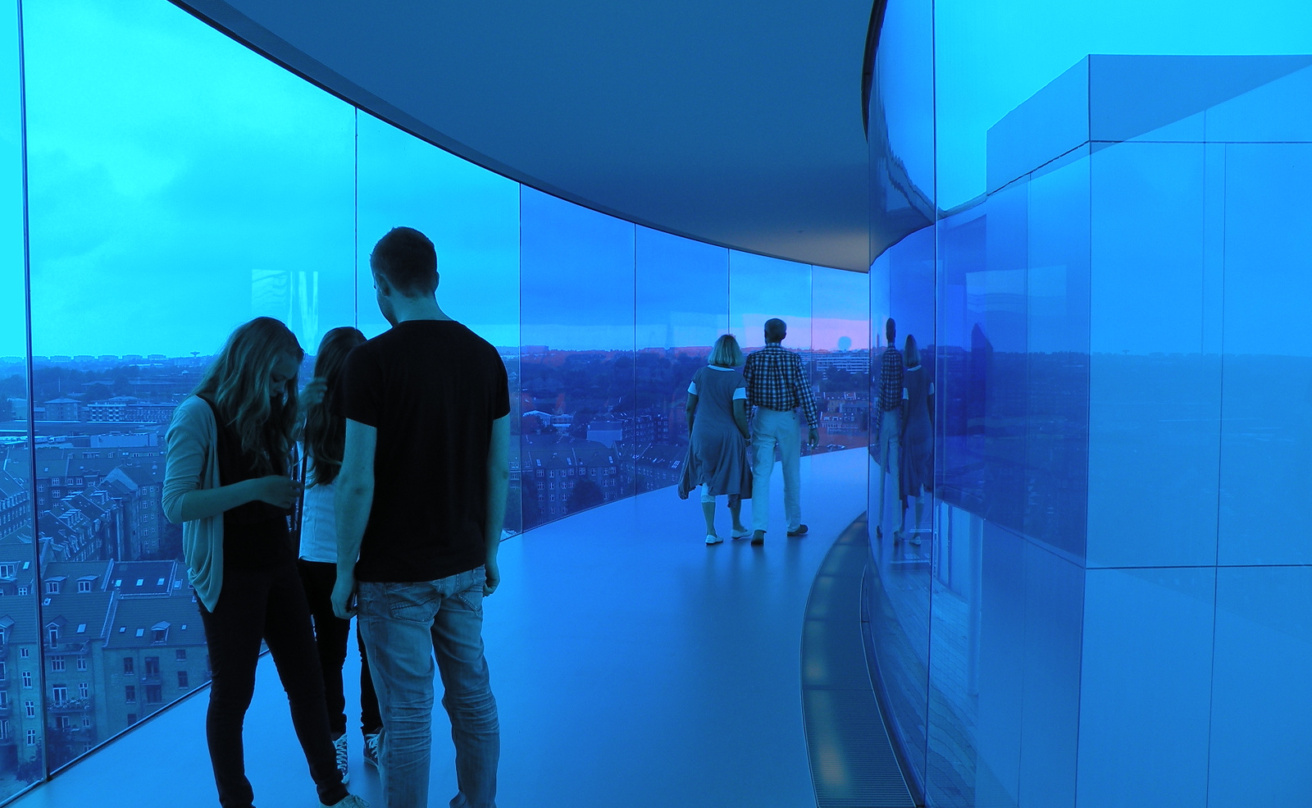 people in blue part of glass tunnel