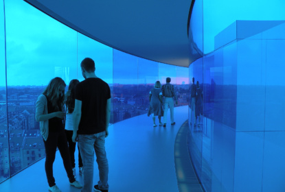 people in blue part of glass tunnel