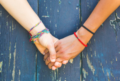 friends holding hands blue backgrund