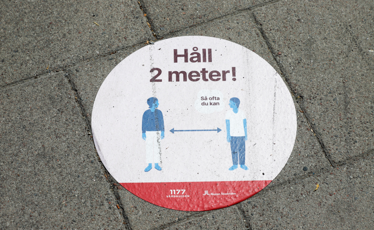 Covid social distance sign on the pavement