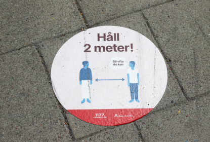 Covid social distance sign on the pavement