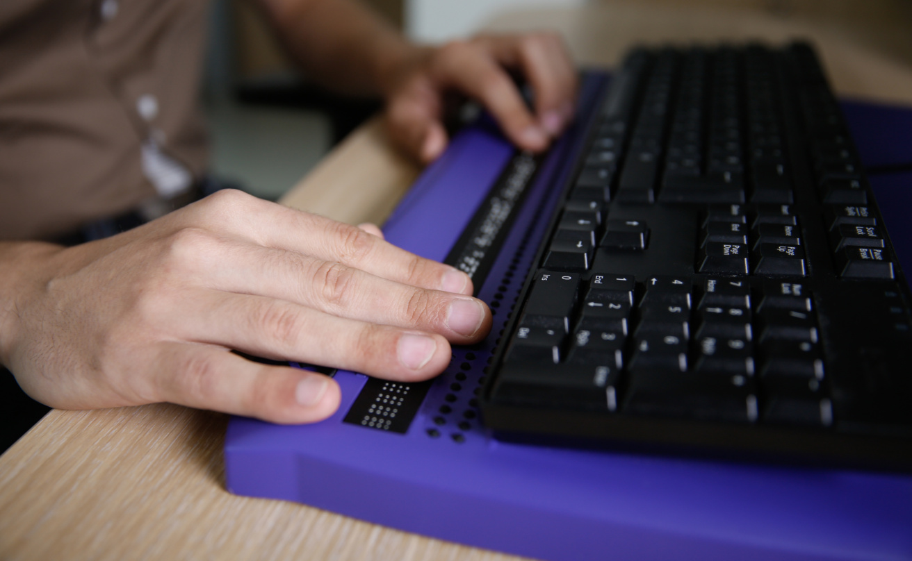 Blind person using computer with braille keyboard