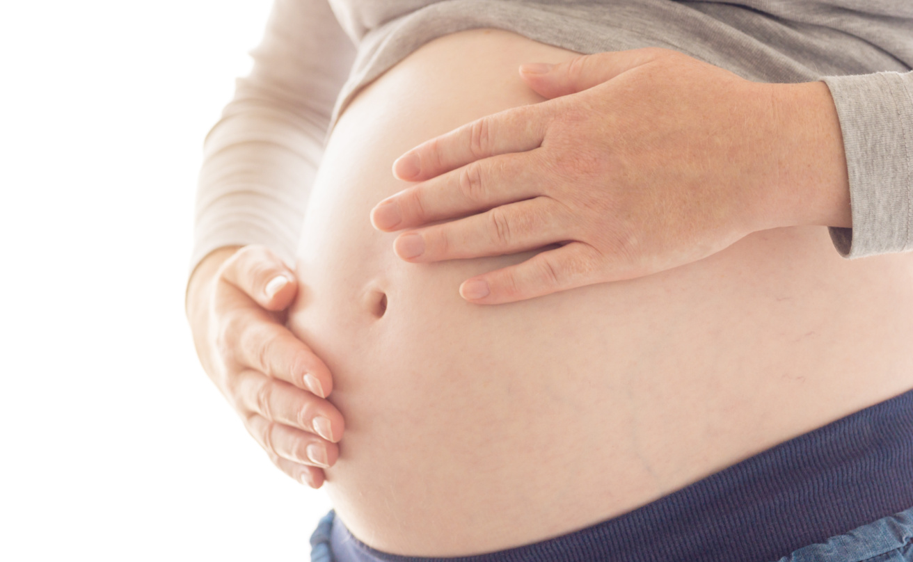 Pregnant woman touching and rubbing her belly