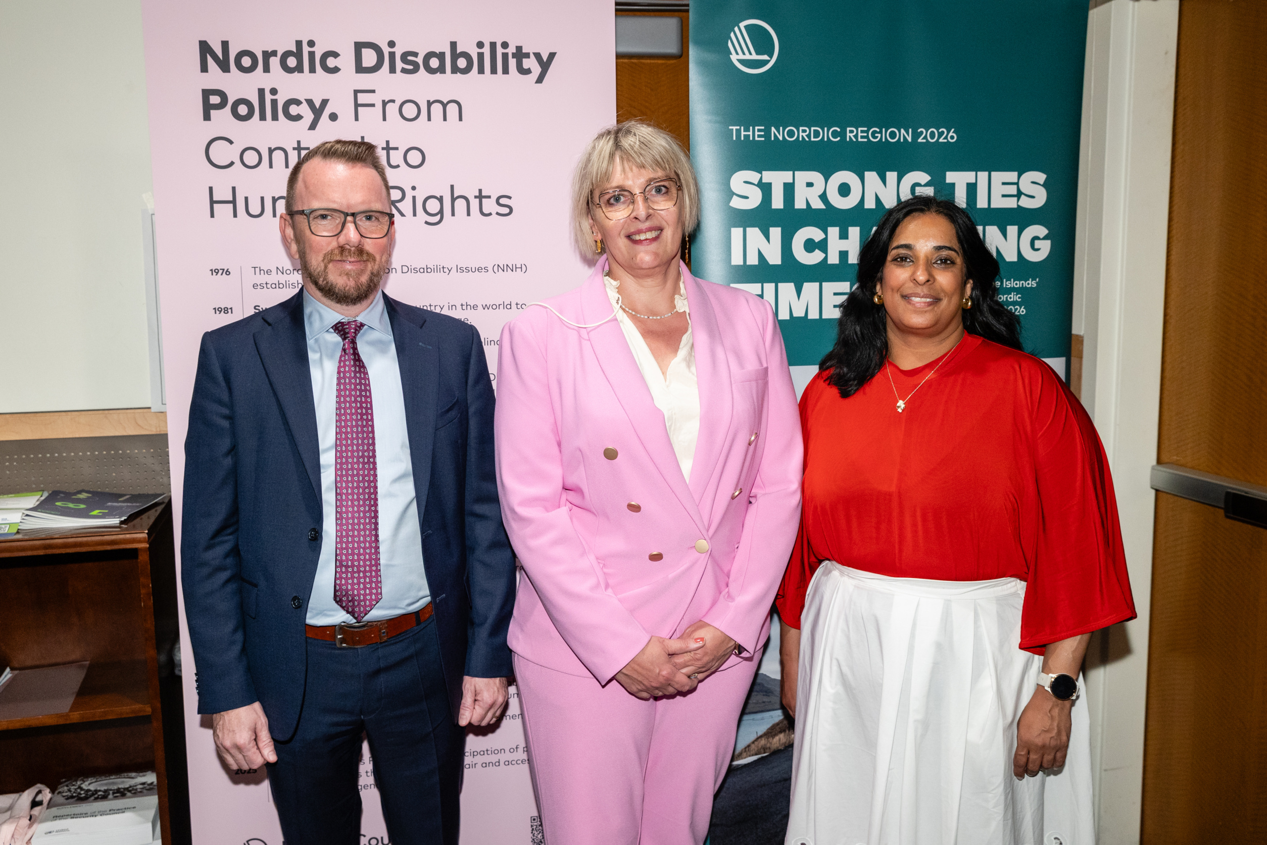Ministers Ragnar Þór Ingólfsson, Margit Storá, and Lubna Jaffery in front of Nordic rollups 