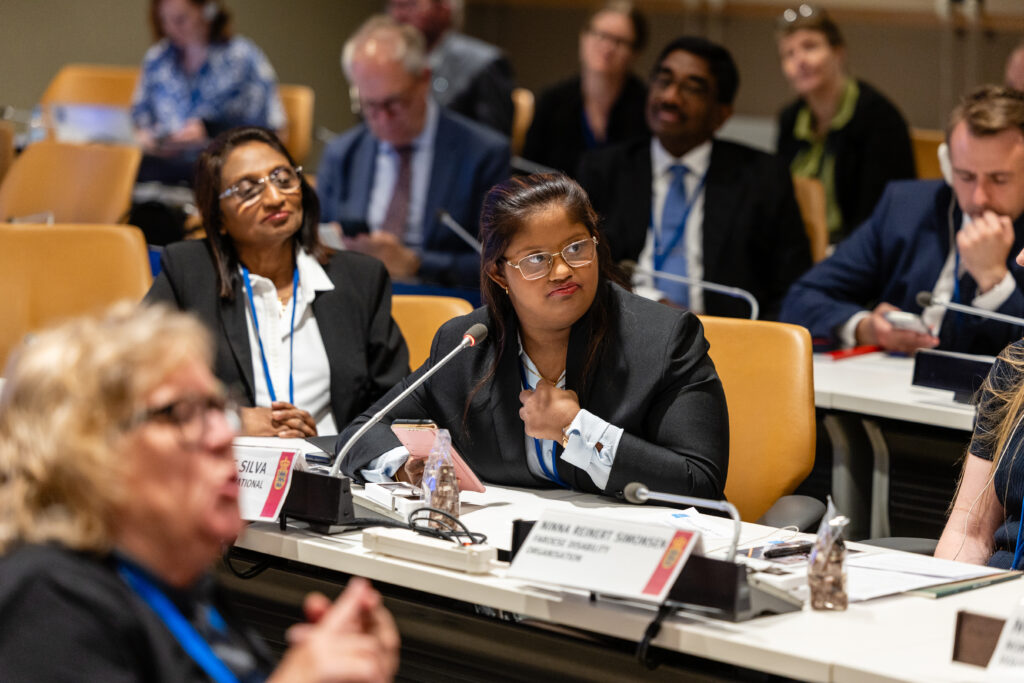 Nilshani De Silva speaking at a conference table