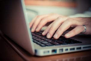 Hands working on computer keyboard