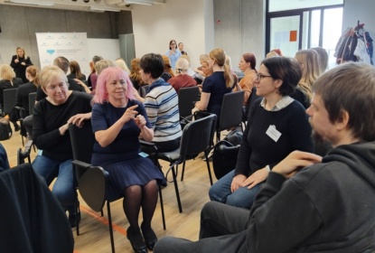 People in a conference room signing