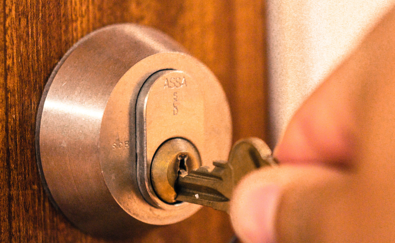 hand placing key in lock