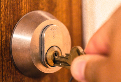 hand placing key in lock