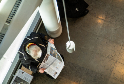A man reading a Swedish newspaper